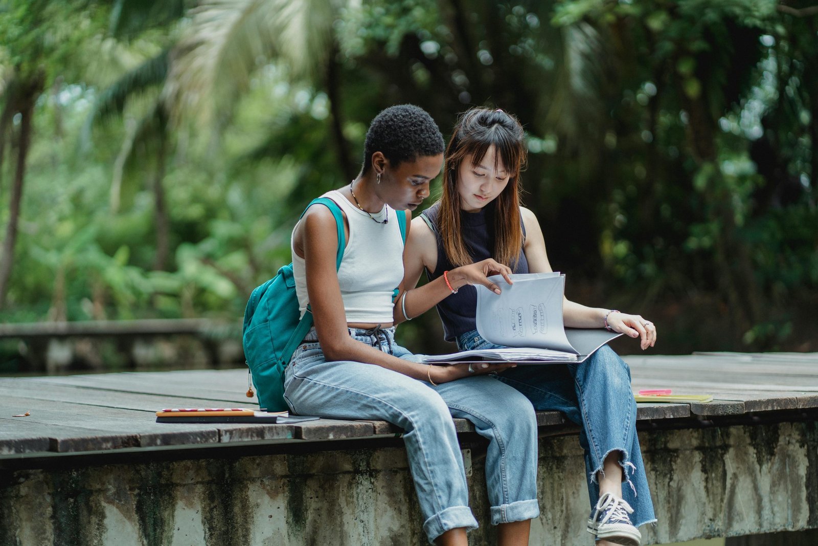 Two people studying outdoors together.